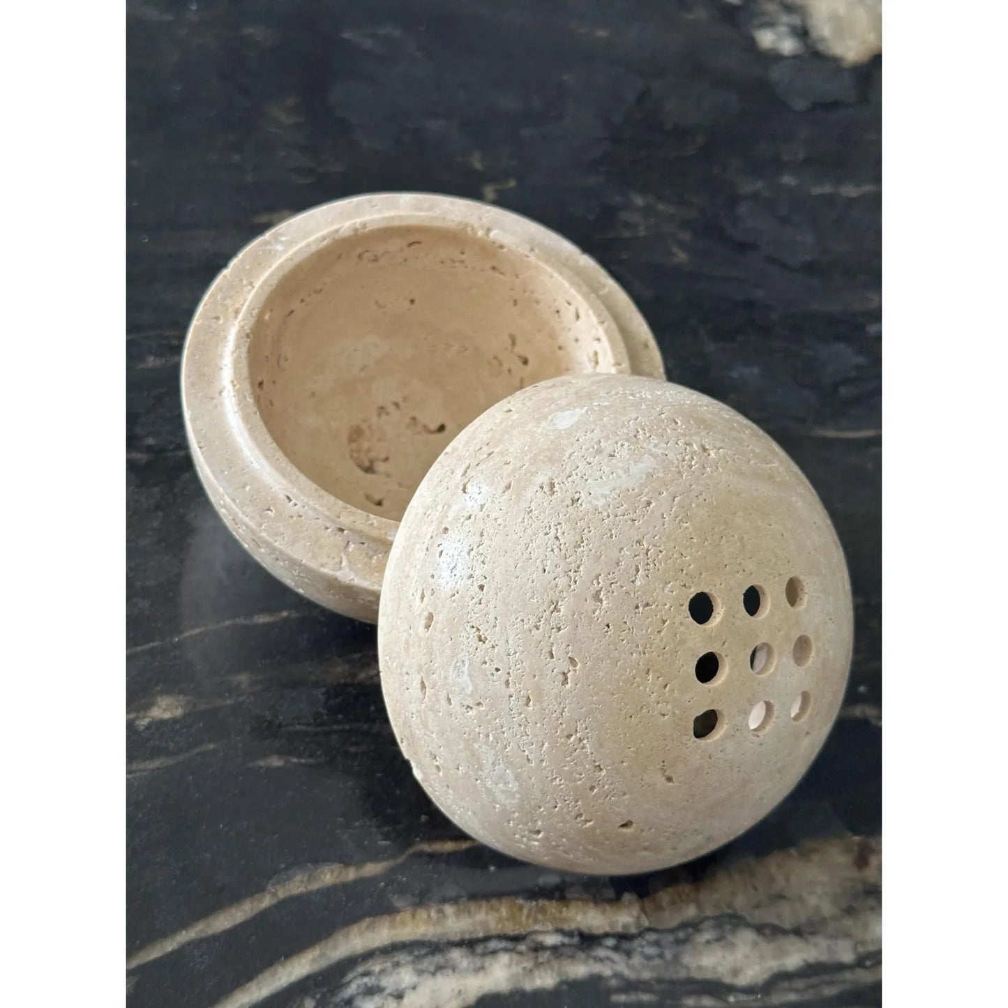 Beige travertine marble sphere incense burner in natural stone with round minimalist design for luxury home decor and aromatherapy top and bottom part seperated