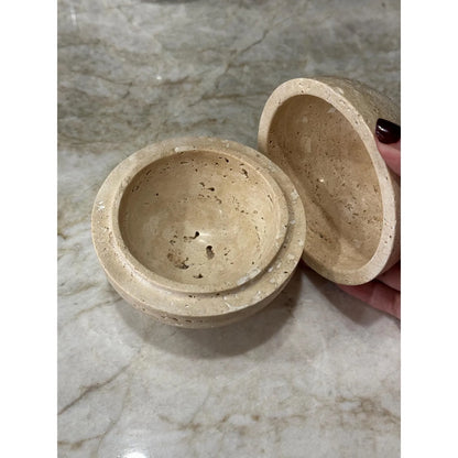 Beige travertine marble sphere incense burner in natural stone with round minimalist design for luxury home decor and aromatherapy with opened up to see inside