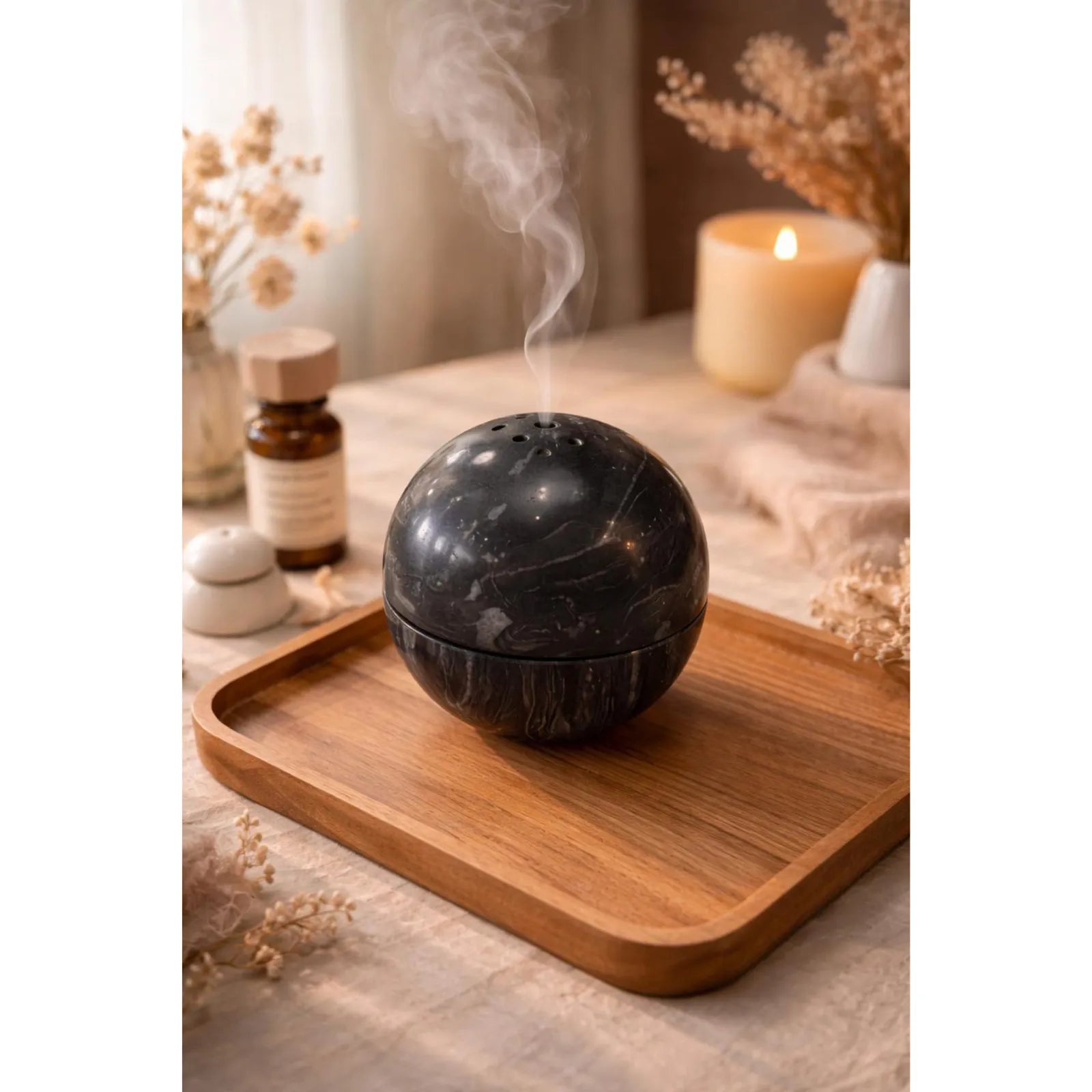 Titanium black marble sphere incense burner with natural stone texture with incense burning smoke