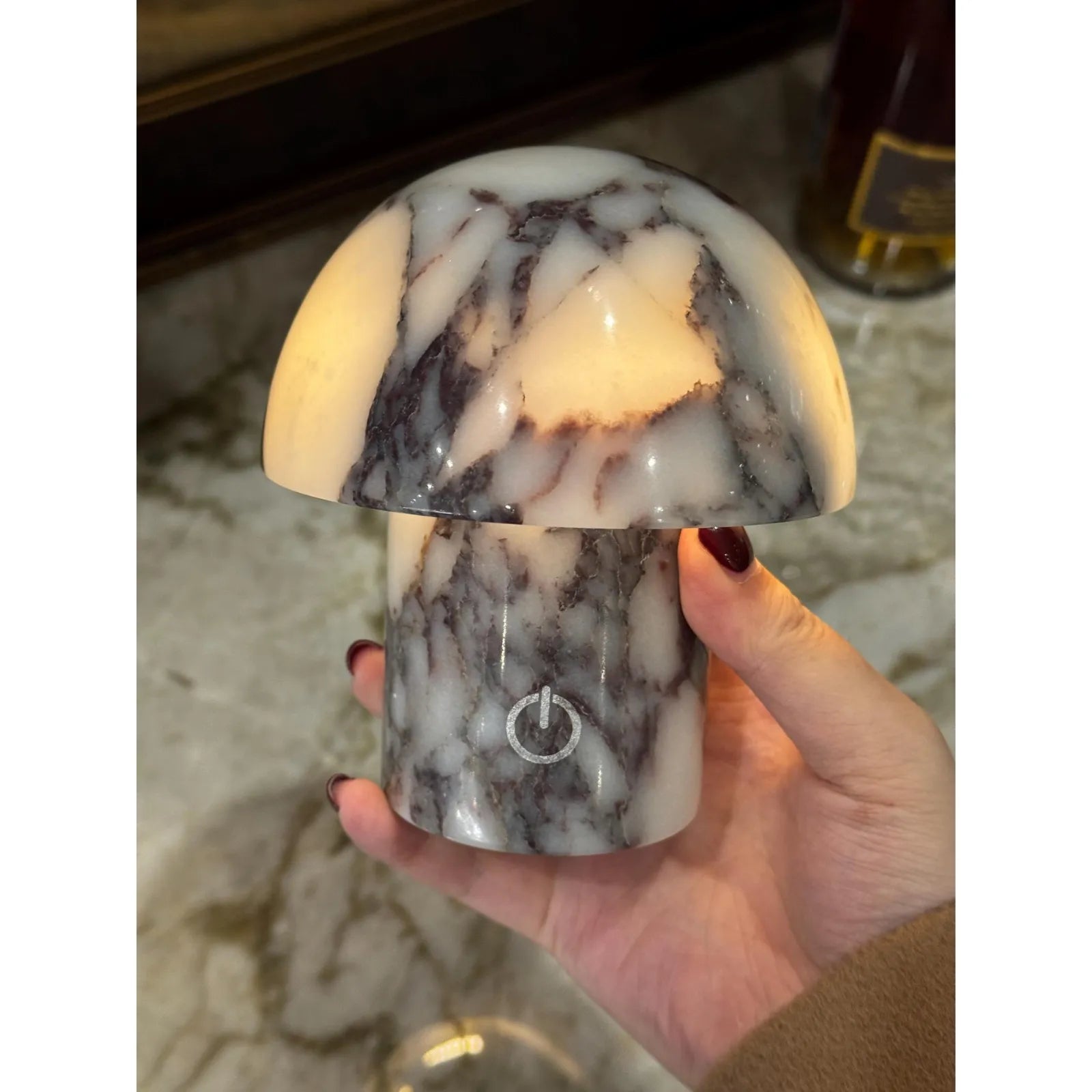 calacatta viola marble mushroom lamp with purple veining in hand