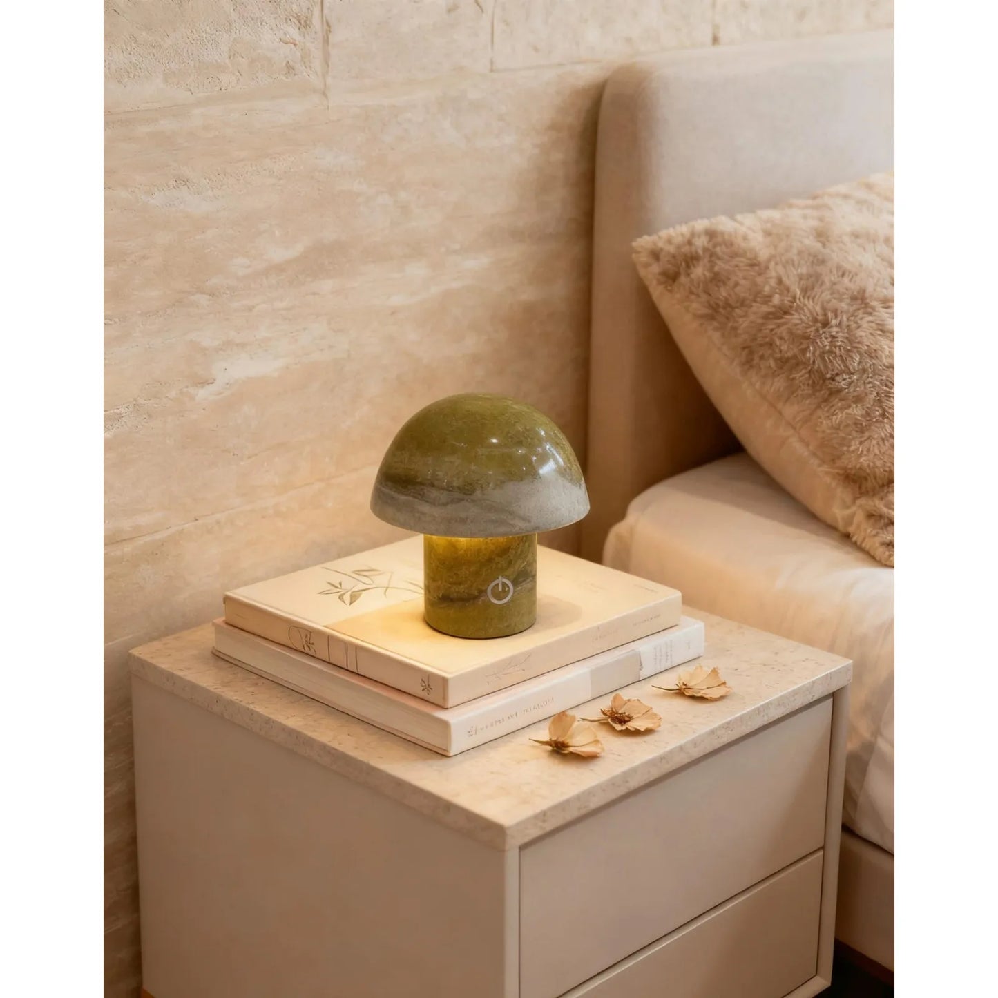 green marble mushroom lamp glowing on a bedside table